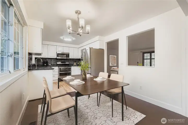 Virtually staged. Dining area off updated kitchen features engineered hardwoods and new lighting fixture. Space can accommodate up seating for up to 6.