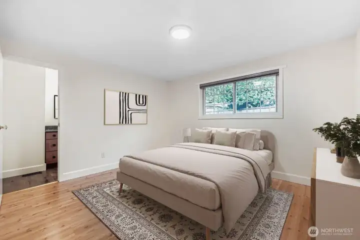 Virtually staged. Primary bedroom with adjacent full bath, large cloest, fresh paint, all new lighting and engineered hardwoods.