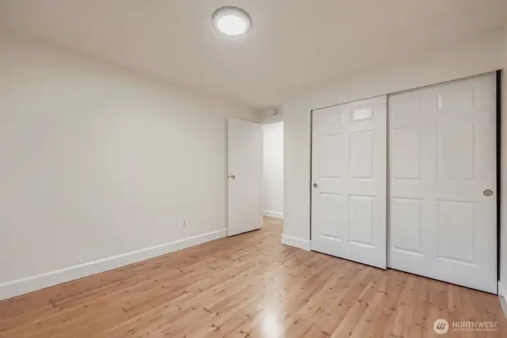 2nd bedroom with large closet, fresh paint, all new lighting and engineered hardwoods.