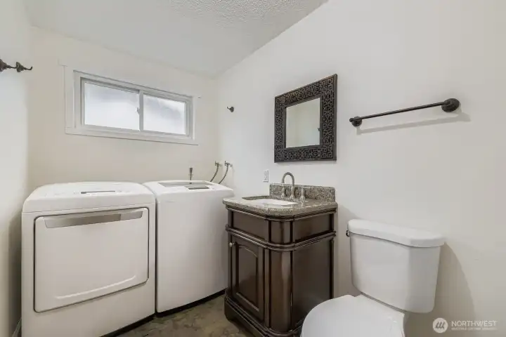 1/2 bath and laundry room. Washer and dryer stay.