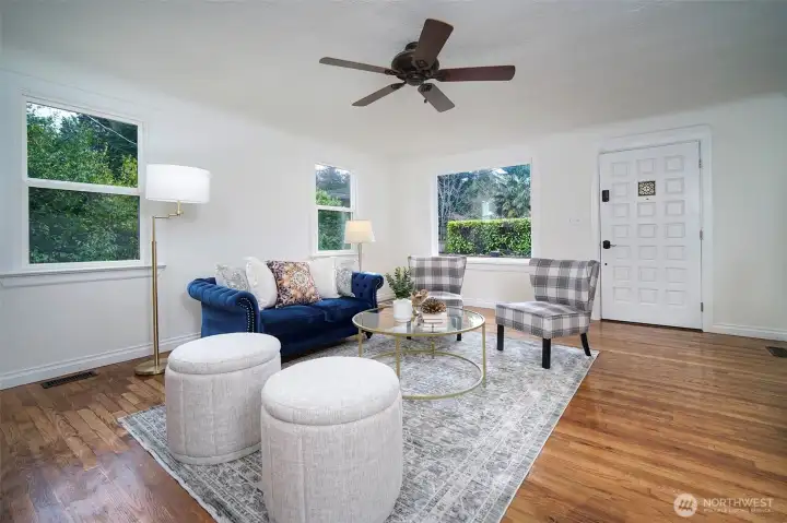 Bright and welcoming living room with abundant natural light and plenty of space for gathering.
