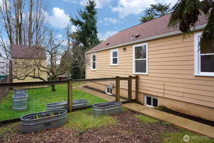 Planting boxes with fruit trees.  This home is a gardeners delight.