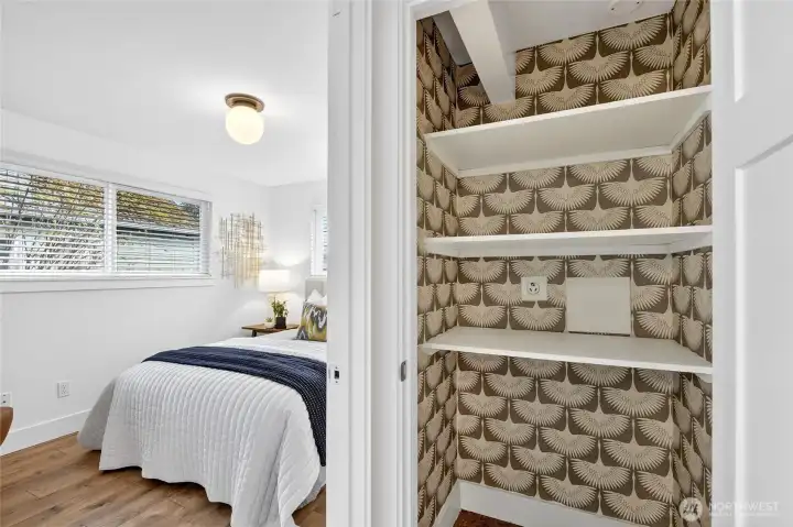 Hall closet has removable shelves and laundry hookups.