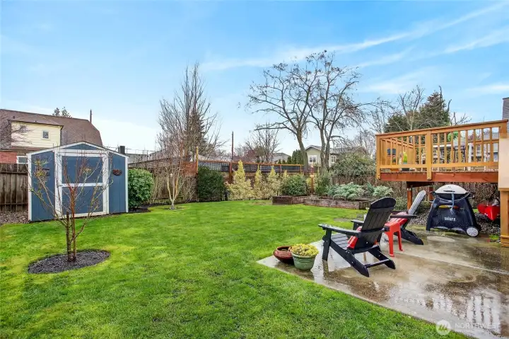 Charming level year with under deck storage for and a stage shed.