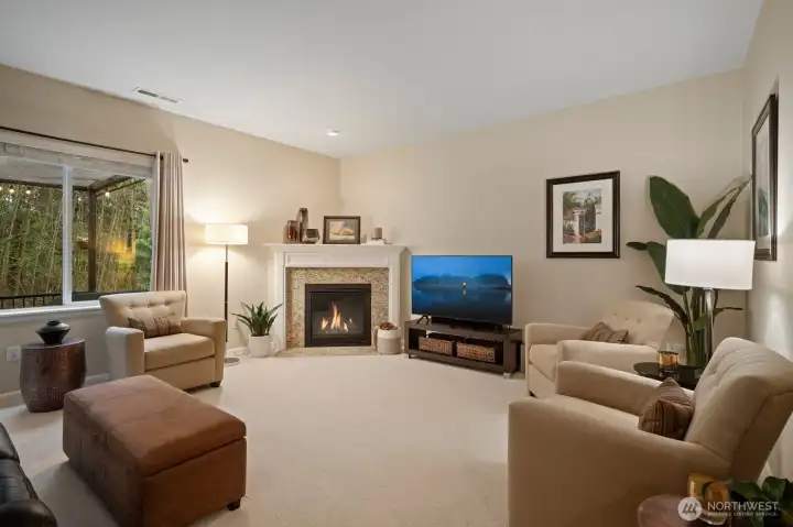Great room features a granite surround gas fireplace.