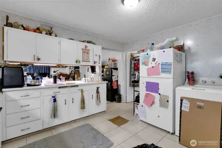The room off to the right of the kitchen is the largest bedroom. It also contains the hot water tank in the closet.