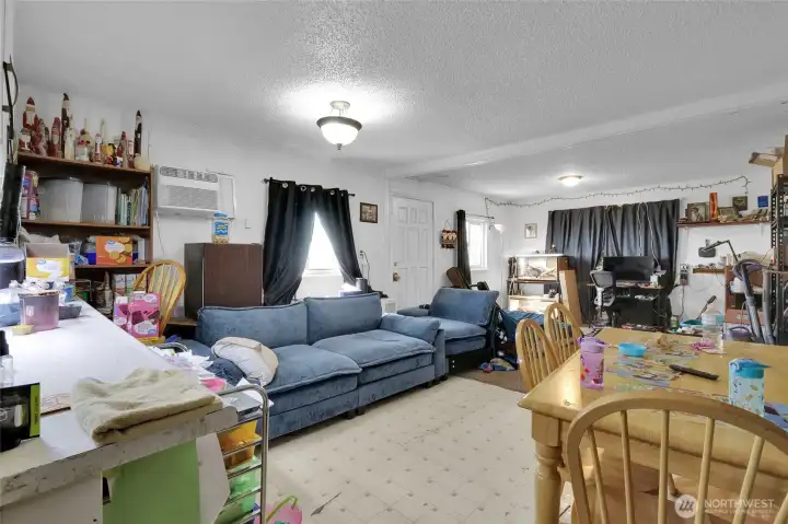 The other half of the front area is the living/dining room. The wall air conditioner keeps it cool in the summer. There are a couple of wall heaters in here that will be replaced soon.