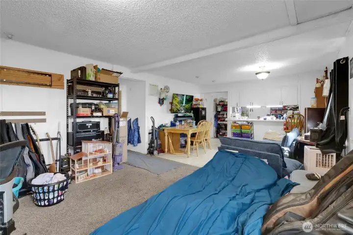 From the living room, looking back at the kitchen and dining area. Two bedrooms are down the hall to the left. Front door is on the right, but not in the photo.