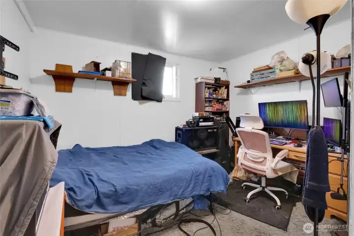 The largest bedroom is off the kitchen.