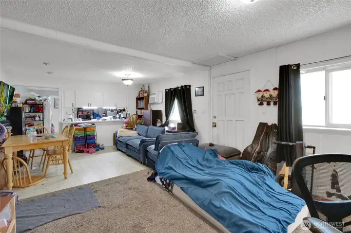 To the right is the front door.  Wall to wall carpeting is in the living room, and vinyl in the dining area. Lots of natural light!