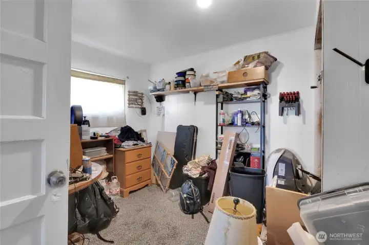 Another view of bedroom 3, a storage/workroom.