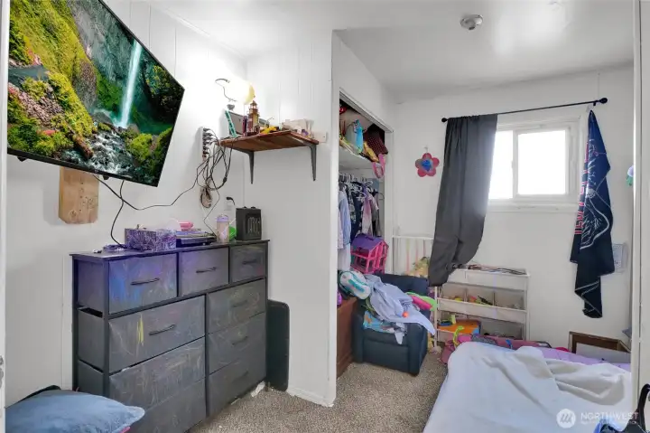 Another view of Bedroom 2 with vinyl window and closet. TV belongs to renter.