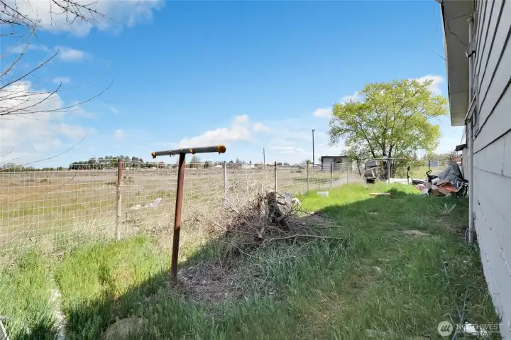 Behind the house. The little building far in the background is the well pump-house.