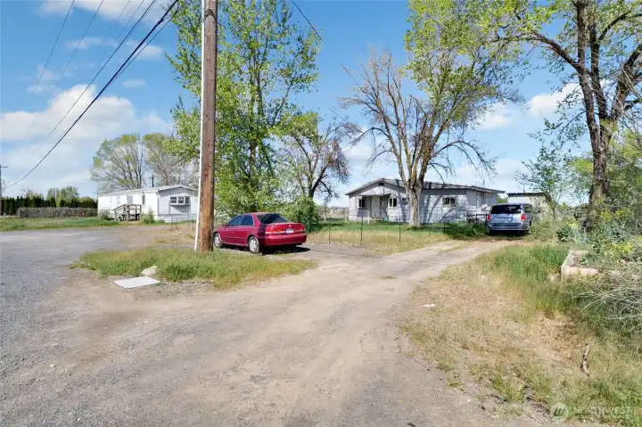 Driveway for rental house. The full acreage is completely fenced in except for an opening on the back corner.