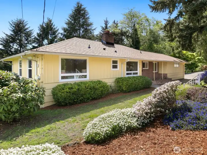 Classic mid-century ranch set on over half an acre, surrounded by mature landscaping in full spring bloom.