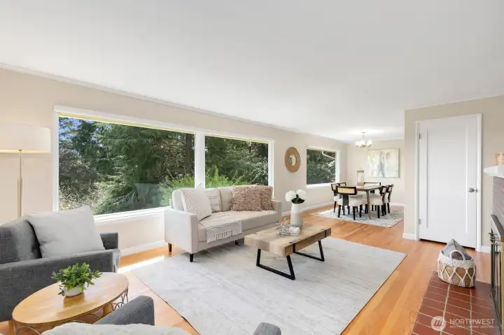 Bright, airy living room with wide territorial views and refinished hardwood floors throughout.