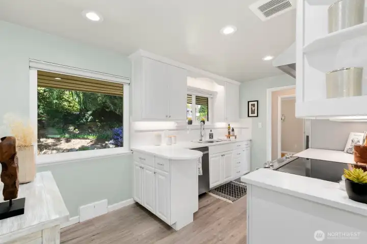Refreshed kitchen with lush frontyard views through the window and plenty of prep space.