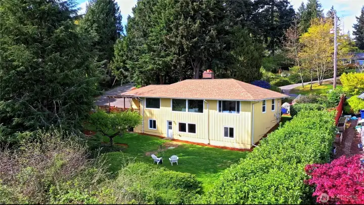 Overhead view from the south, showing the home's many windows which enjoy an open view of the backyard and beyond!
