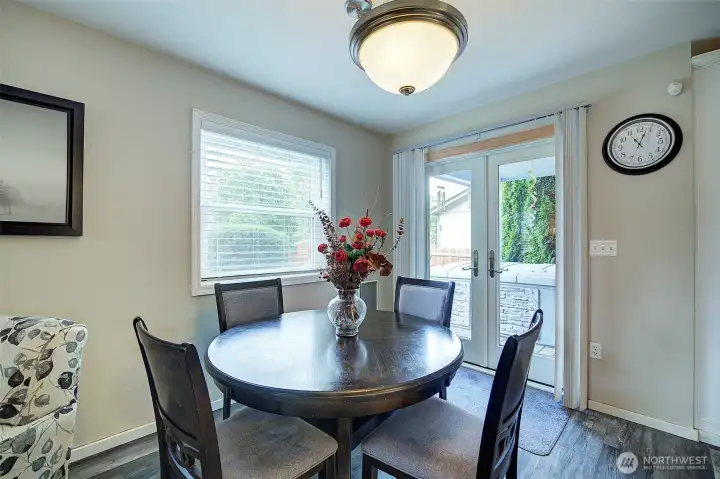 Dining area with French doors opening to a private deck, perfect for indoor-outdoor living. Dining area with French doors opening to a private deck, perfect for indoor-outdoor living.