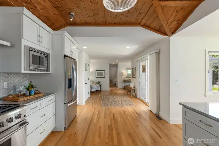 View from the kitchen. Sliding doors on right lead to a front yard water view deck.  On the left is the back door entry from the carport for easy grocery drop off.