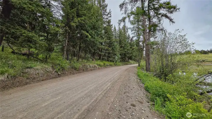 Looking north up Davies Road. This exceptionally wide, county-maintained route provides incredibly reliable year-round access, making it a breeze to bring in RVs, trailers, or heavy building equipment!