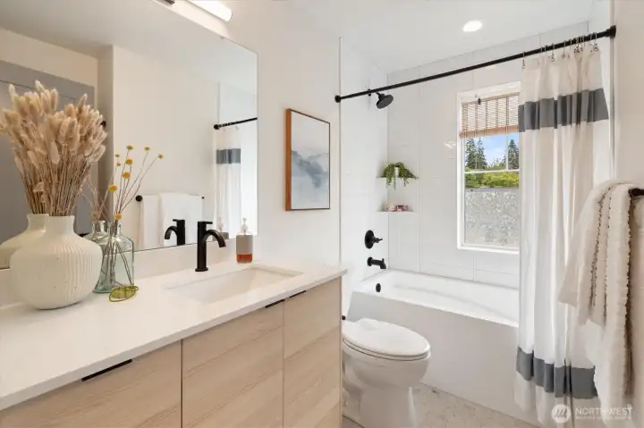 The bathroom is sophisticated with white tile accents and a soaking tub to enjoy. The bathroom is sophisticated with white tile accents and a soaking tub to enjoy.