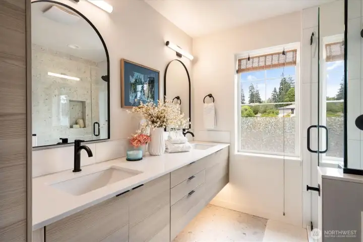 The primary en-suite bath features double vanities with a gorgeous tile floor and three/quarter bath. The primary en-suite bath features double vanities with a gorgeous tile floor and three/quarter bath.
