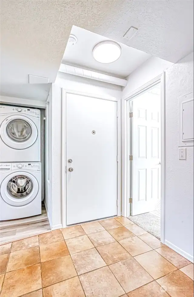 Entry with door to the bedroom & next to laundry closet.