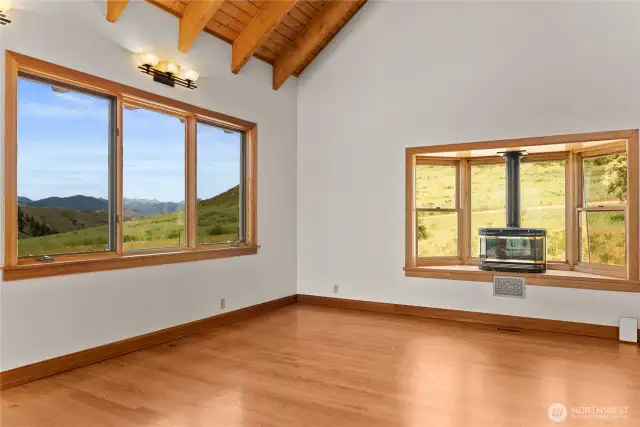 Living room with propane heat, bay window and Northern views of the mountains.