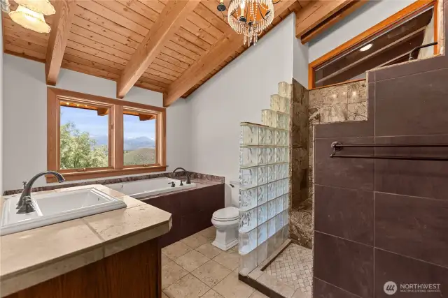 On-suite full bath with a dynamic mix of wood, tile and glass.