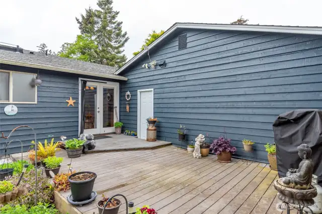 Spacious deck with doors to the garage and into the dining room.