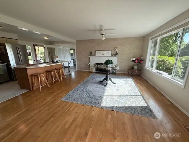 Open floor plan with real hardwood floors, wood fireplace, huge windows that let light in and beautiful views of the surrounding pastures