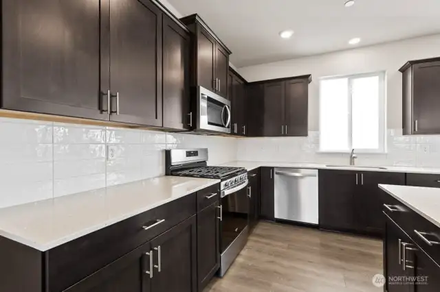 Gas cooktop and stainless-steel appliances; Colors, finishes, and options will vary.