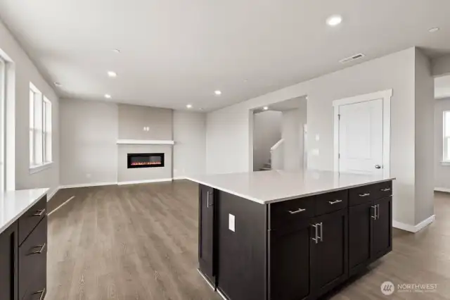 View from kitchen into great room; fireplace not offered at Bakerview; Colors, finishes, and options will vary.