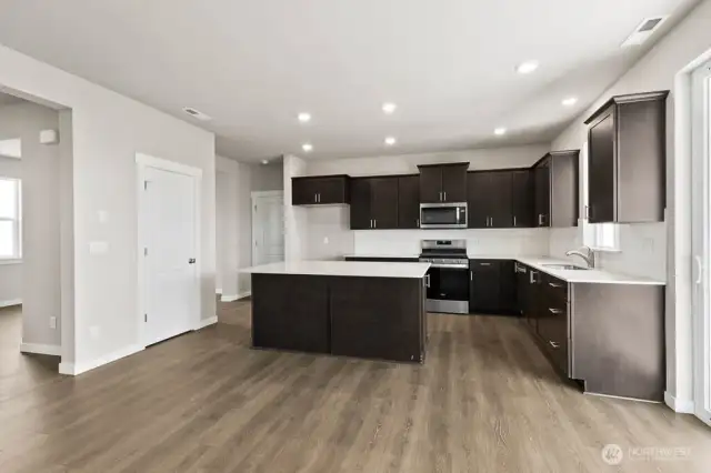 View from Great Room into kitchen; Colors, finishes, and options will vary.