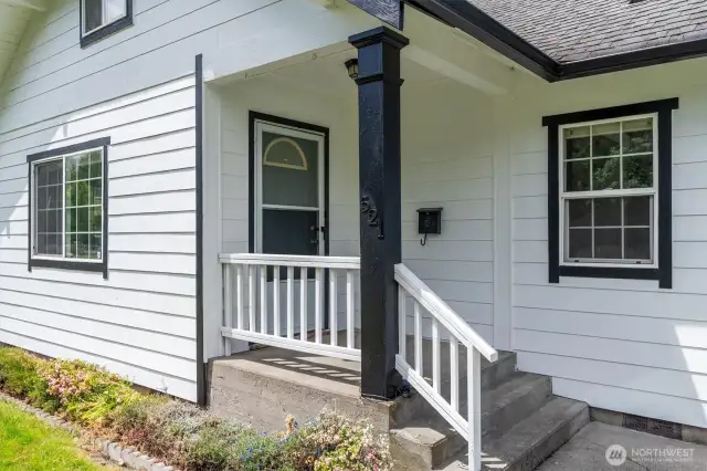 Covered front porch keeping all of your deliveries dry.