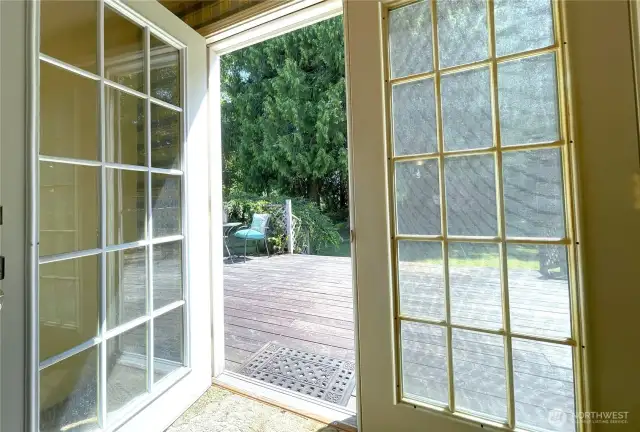 French doors lead to the enormous back deck and private back yard.