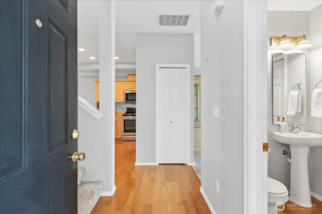 Entry with oak hardwoods. Neutral gray walls throughout.