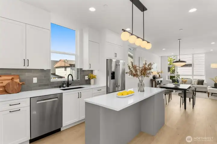 Floating island anchors the kitchen, ideal for prepping, dining, or gathering with guests.