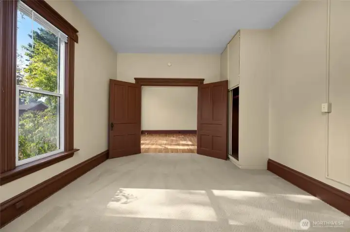 French doors lead into the primary bedroom from the living room.