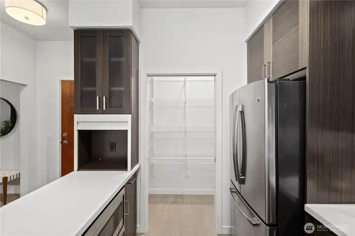 Luxury details abound, from the quartz countertops, appliance garage to the expansive walk-in pantry.
