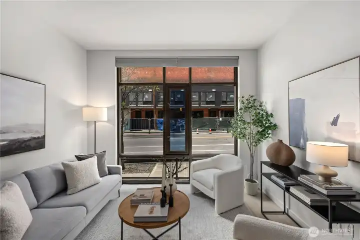 Soaring 10-foot ceilings and dramatic floor-to-ceiling windows flood the home with natural light while automated dual-direction blinds offer effortless privacy and comfort. The west-facing exposure creates a bright, inviting atmosphere throughout the day and warm evening light to enjoy at home.