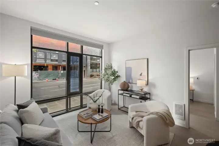 Bright, open, and welcoming, the living room features floor-to-ceiling glass and automated dual-direction blinds that enhance both style and functionality.