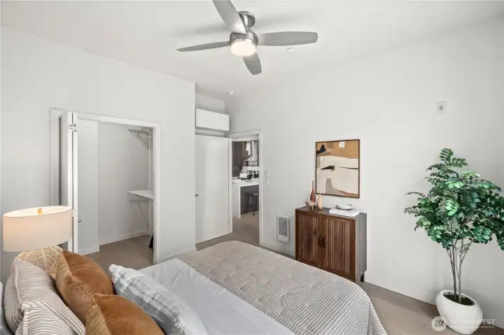 Floor-to-ceiling windows flood the bedroom with natural light, while automated dual-direction blinds, a walk-in closet, and a ceiling fan enhance everyday living.