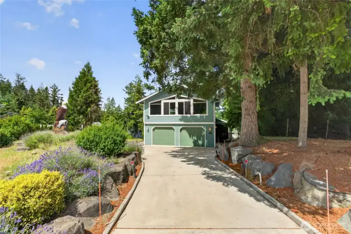 A lovely landscape with decorative stones & wood carvings greet you. The newer concrete drive & curbing make parking easy A lovely landscape with decorative stones & wood carvings greet you. The newer concrete drive & curbing make parking easy