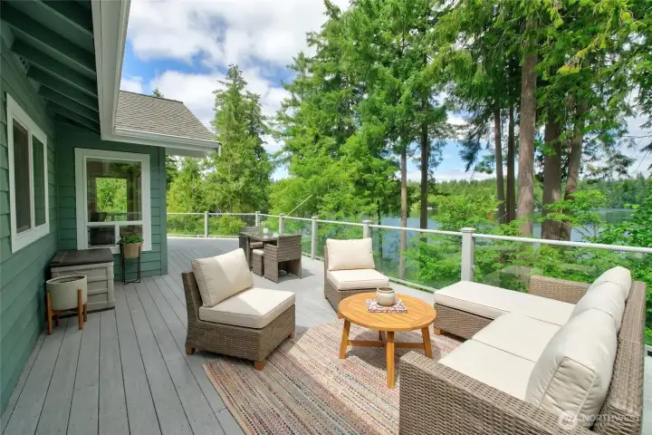 Outdoor living on the expansive deck offers a space to relax or dine while enjoying the stunning views. *photo virtually staged Outdoor living on the expansive deck offers a space to relax or dine while enjoying the stunning views. *photo virtually staged