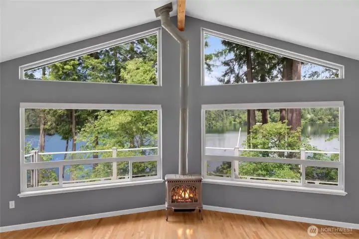 This could be your view every day where soaring windows & vaulted ceilings frame the beautiful trees and tranquil lake. The propane fireplace is a cozy accent on a chilly day where you can snuggle up with a good book & your favorite beverage This could be your view every day where soaring windows & vaulted ceilings frame the beautiful trees and tranquil lake. The propane fireplace is a cozy accent on a chilly day where you can snuggle up with a good book & your favorite beverage