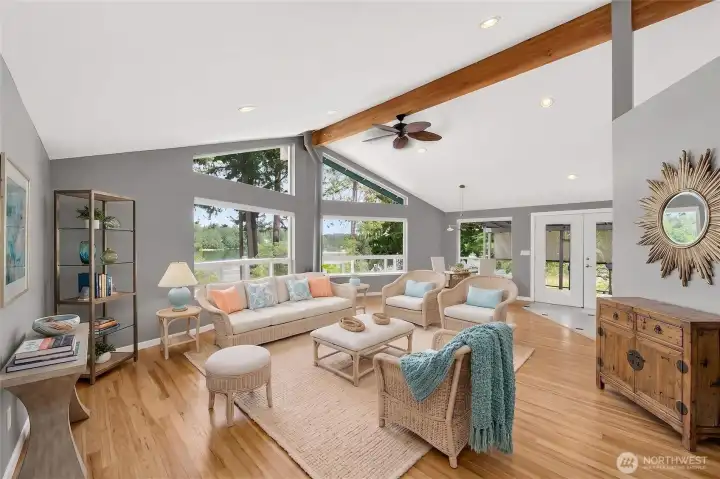 The great room features warm, real wood flooring and a beautiful beam & decorative ceiling fan. *Photo virtually staged The great room features warm, real wood flooring and a beautiful beam & decorative ceiling fan. *Photo virtually staged