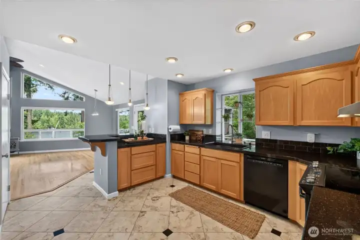 The kitchen is a lovely space to craft meals with maple cabinetry with handy slide-outs and beautiful tile flooring The kitchen is a lovely space to craft meals with maple cabinetry with handy slide-outs and beautiful tile flooring