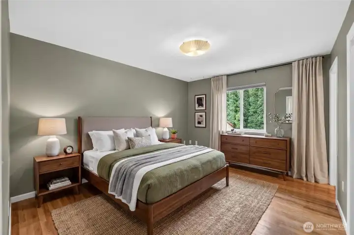 The main level primary bedroom with hardwood flooring & a walk-in closet is a perfect retreat at the end of a busy day. The main level primary bedroom with hardwood flooring & a walk-in closet is a perfect retreat at the end of a busy day.